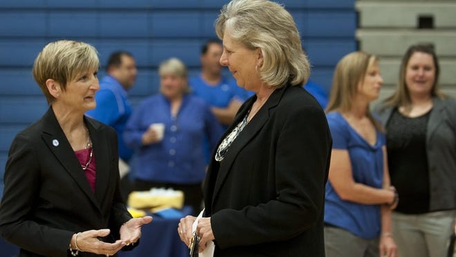 Pflugerville High girls basketball coach Nancy Walling, right, chats with Pflugerville ISD athletic director Johanna Denson on Friday, when Walling announced her plans to retire after 25 seasons as the Panthers’ head coach. CREDIT: Andy Sharp/For American-Statesman