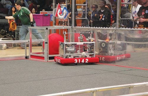 Newton’s Aperture 3142 scores in the low goal at a district competition.