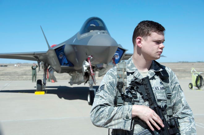 Senior Airman Ryan T. Albritton, 82nd Security Forces Squadron, stands just behind the cordon perimeter protecting the F-35 lightning II while Sheppard Airmen take the opportunity to see it up close March 11 at Sheppard Air Force Base, Texas from Eglin Air Force Base as part of a hurricane evacuation exercise that would allow aircraft from Eglin to migrate to Sheppard if threatened by a hurricane.
