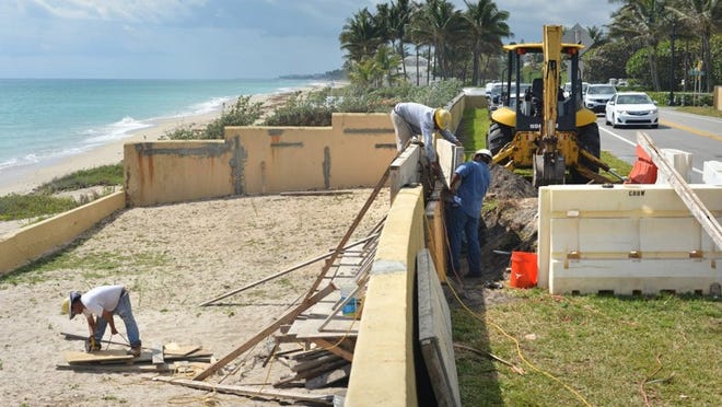 A crew with The Murphy Construction Co. repairs a section of sea wall Thursday morning at 910 S. Ocean Blvd.