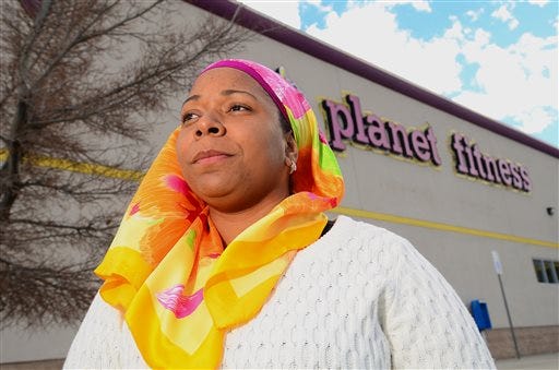 Tarainia McDaniel is photographed in front of Planet Fitness in Albuquerque, N.M., March 2, 2014. The Albuquerque Planet Fitness refused to let McDaniel a New Mexico Muslim woman, wear her religious head covering when she tried to work out, according to a new lawsuit. An attorney for McDaniel, 37, recently filed the lawsuit in a New Mexico district court stemming after a 2011 clash that prevented McDaniel from using the gym, even though court documents said another Planet Fitness had previously let her.