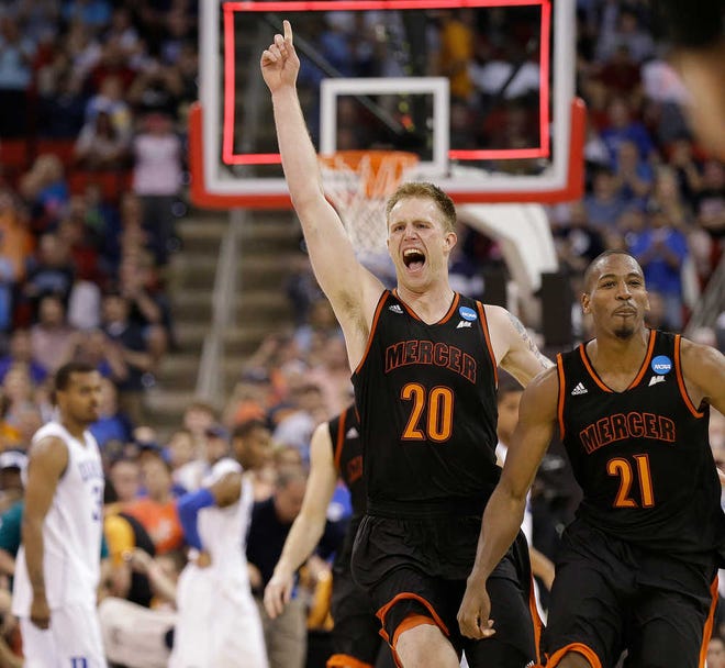 Mercer forward Jakob Gollon (20) and guard Langston Hall (21) celebrate after defeating Duke 78-71 in an NCAA college basketball second-round game against Duke, Friday, March 21, 2014, in Raleigh, N.C.(AP Photo/Gerry Broome)