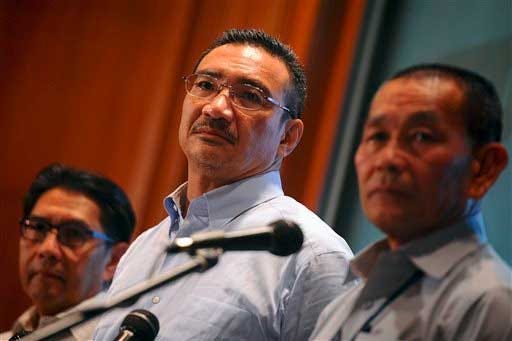 Malaysian Defense Minister Hishammuddin Hussein, center, Malaysia's Department of Civil Aviation director general Azharuddin Abdul Rahman, left, and Malaysia Airlines Group Chief Executive Ahmad Jauhari Yahya listen to a question of a journalist during a press conference at a hotel in Sepang, Malaysia, Saturday, March 22, 2014.