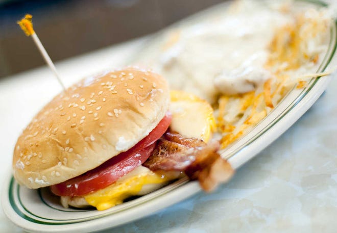 FILE - In this Wednesday, June 26, 2013, file photo, a breakfast sandwich is photographed at the Triple XXX restaurant in West Lafayette, Ind. Breakfast is now being served with a dose of sticker shock. The cost of morning staples like bacon, coffee and orange juice is surging on a host of global supply problems, from drought in Brazil to disease on U.S. pig farms. (AP Photo/Journal & Courier, Brent Drinkut)