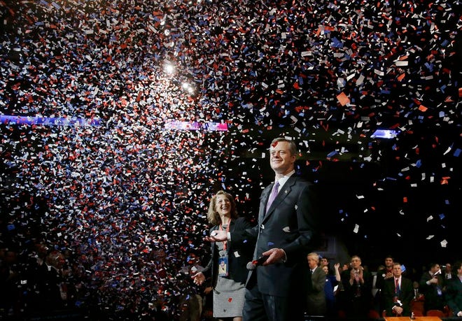 Charlie Baker, the frontrunner and favorite in the Republican nomination for governor, stands with his wife, Lauren, at the Massachusetts Republican state convention in Boston, Saturday, March 22, 2014.