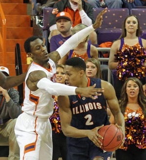 Clemson's Adonis Filer, left, defends against Illinois' Joseph Bertrand during the first half of their NCAA college basketball National Invitational Tournament game at Littlejohn Coliseum in Clemson, S.C., Sunday, March 23, 2014. (AP Photo/Anderson Independent-Mail, Mark Crammer) GREENVILLE NEWS OUT; SENECA NEWS OUT