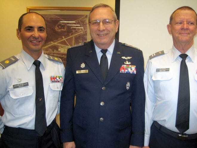 CONTRIBUTED Civil Air Patrol Florida wing commander Col. Michael Cook is surrounded by outgoing squadron commander Ralph Aviles and new squadron commander Capt. Gene Melton.