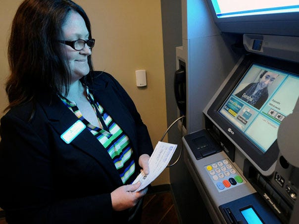 Corning Credit Union member service representative Julie Tyndall gives a demo on the new video teller machine at Corning Credit Union in Leland, North Carolina Tuesday, March 18, 2014.