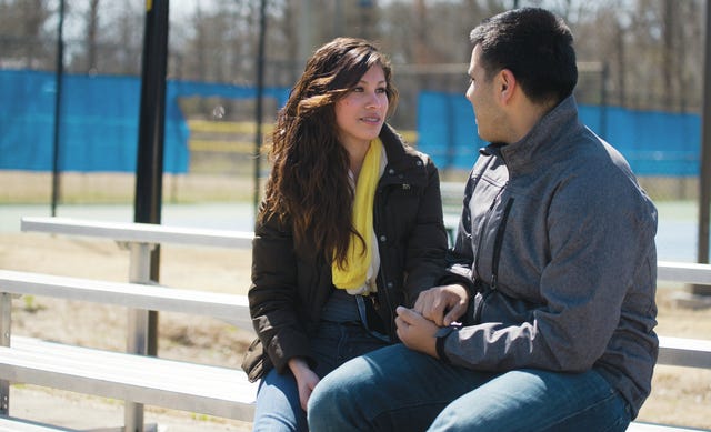 Jennifer Estrada of Asheboro and Irving Arias of Liberty hold hands while enjoying the spring like weather at Memorial Park before the temperature is to drop tonight for a possible winter mix in Asheboro on March 24,2014. PJ Ward-Brown/The Courier-Tribune