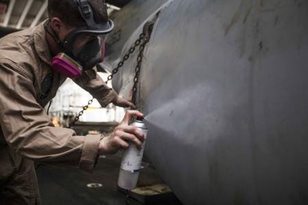 U.S. Marine Corps Sgt. Tyler Deckard, Marine Medium Tiltrotor Squadron (VMM) 263 (Reinforced), 22nd Marine Expeditionary Unit (MEU), corrosion control noncommissioned officer in charge and native of Bartlesville, Okla., touches up some chips and scratches in the paint of an MV-22 Osprey aircraft to protect the aircraft from corrosion aboard the USS Bataan (LHD 5). Many of the aircraft’s markings were hand painted or custom created by Deckard and other MEU Marines, including the squadron’s logo on the tail of the Ospreys. The 22nd MEU is deployed with the Bataan Amphibious Ready Group as a theater reserve and crisis response force throughout U.S. Central Command and the U.S. 5th Fleet area of responsibility.
