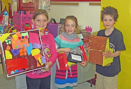 Second-grade Centre School students Lillie, Maia and Jack show off their Fairy Tale buildings. 
Lisa Tetrault-Zhe photo