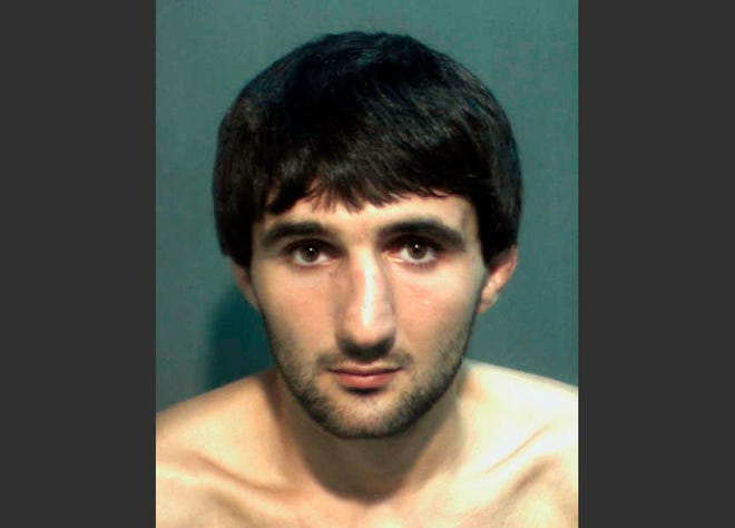 FILE - This May 4, 2013 file photo provided by the Orange County Corrections Department in Orlando, Fla., shows Ibragim Todashev after his arrest for aggravated battery in Orlando. A report released Tuesday, March 25, 2014, determined that an FBI agent was justified in fatally shooting Todashev, who became violent after he had agreed to give a statement about his involvement in a triple slaying in Massachusetts last May. (AP Photo/Orange County Corrections Department)
