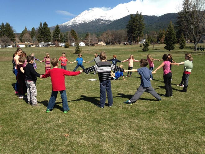 Students at Strawberry Valley School (held on the Sisson campus) learn in a hands-on way, often in multi-age groups. Above, they are learning about pi on Pi Day out on the field.