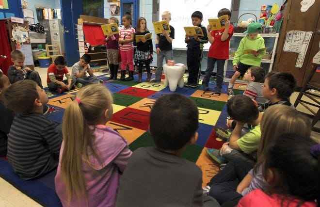 (John Clark/The Gaston Gazette)  Students in Robin Medlock's kindergarten class at Lowell Elementary School participate in the reader's theatre which is an interactive reading activity that was purchased with grant money she received last year.