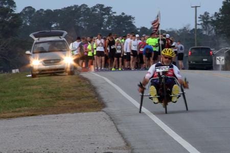 Paul Kelly, avid hand-cyclist, takes off from the starting line of the15th Annual Marine Corps Air Station Cherry Point Half Marathon March 22, 2014. Kelly, a retired electronics engineer with Naval Air Systems Command, started participating in various races and events in 2008 with the hopes of raising money and awareness for wounded service members.