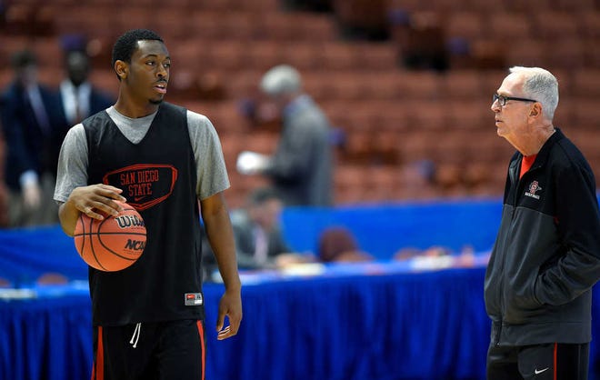 San Diego State coach Steve Fisher, right, talks with guard Xavier Thames during practice at the NCAA college basketball tournament, Wednesday, March 26, 2014, in Anaheim, Calif. San Diego State is scheduled to play Arizona on Thursday in a regional semifinal. (AP Photo/Mark J. Terrill)