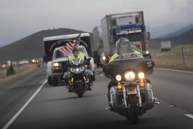 Two motorcyclists with the Missing in Action Project ride with the escort convoy for the American Veterans Traveling Tribute wall from the Weed Rest Area to the Siskiyou Golden Fairgrounds on March 26.