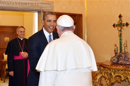 Pope Francis welcomes President Barack Obama as Archbishop George Gaenswein, background left, look at them, at the Vatican Thursday, March 27, 2014. President Barack Obama is holding a historic first meeting with Pope Francis, the pontiff that the president views as a kindred spirit on issues of economic inequality and the poor. Obama arrived at the Vatican Thursday morning amid the pomp and tradition of the Catholic Church, making his way to greet the pope after a long slow procession. (AP Photo/Gabriel Bouys, Pool)