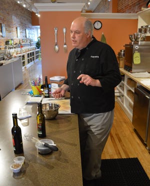 Chef Andy Stewart, corporate chef for Fustini's Oils and Vinegars, conducts a cooking class at the downtown Holland store. Delbridge Langdon Jr./Sentinel contributor