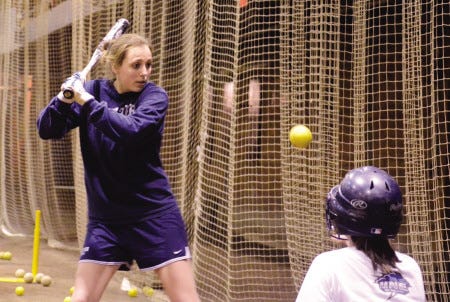 Exeter High School senior Kate Dawson (left) works 
on a soft-toss 
hitting drill during Wednesday’s softball 
practice at Phillips Exeter Academy. Monday marked the first week of practice for spring sports.

Ryan O’Leary photo