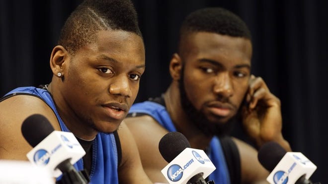 Florida forward Will Yeguete (15), left, speaks during a news conference as center Patric young looks on Friday, March 28, 2014 in Memphis, Tenn. Florida will play Dayton Saturday in an NCAA college basketball tournament regional championship game. (AP Photo/Mark Humphrey)
