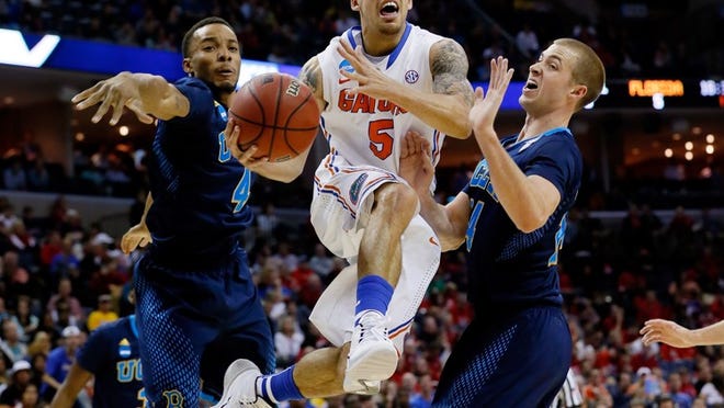MEMPHIS, TN - MARCH 27: Scottie Wilbekin #5 of the Florida Gators drives to the basket as Norman Powell #4 and Travis Wear #24 of the UCLA Bruins defend during a regional semifinal of the 2014 NCAA Men's Basketball Tournament at the FedExForum on March 27, 2014 in Memphis, Tennessee. (Photo by Kevin C. Cox/Getty Images)