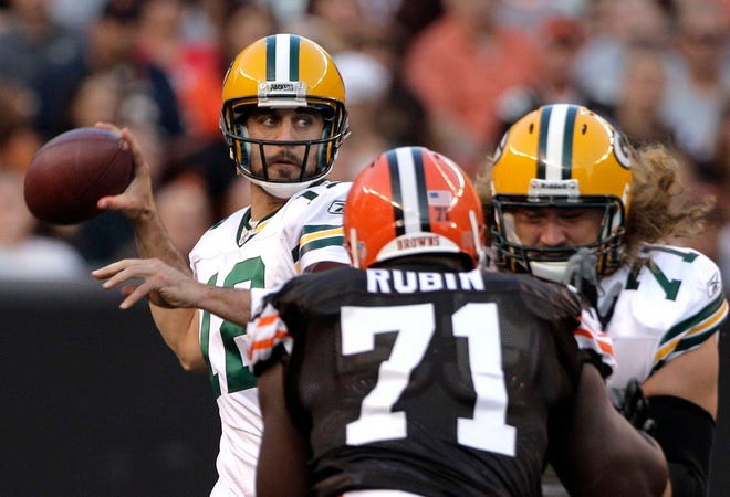 Green Bay Packers quarterback Aaron Rodgers goes back to pass as Browns defensive tackle Ahtyba Rubin applies pressure.