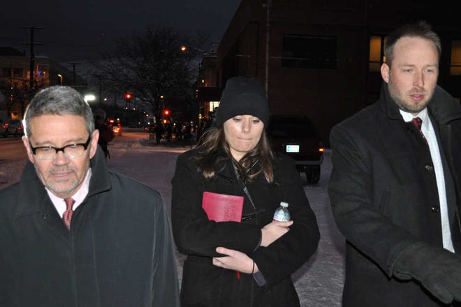 FILE - In this Tuesday, Dec. 10, 2013 file photo, Jordan Graham, center, is flanked by defense attorneys Michael Donahoe, left, and Andy Nelson, as she leaves court in Missoula, Mont. The Montana woman who was to be sentenced Thursday for pushing her new husband to his death in Glacier National Park wants to withdraw her guilty plea to a second-degree murder charge, her lawyer said Tuesday March 25, 2014. (AP Photo/Stephan Ferry, File)