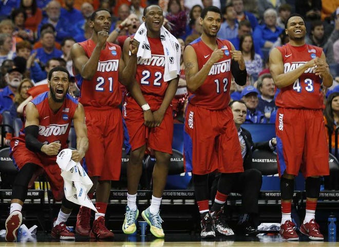 Dayton players celebrate a three-point shot against Stanford during the second half in a regional semifinal game at the NCAA college basketball tournament, Thursday, March 27, 2014, in Memphis, Tenn. Dayton won 82-72. (AP Photo/John Bazemore)
