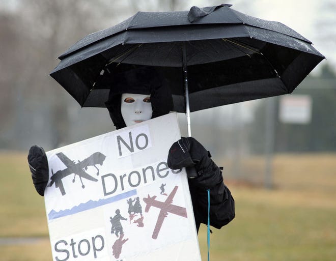 HORSHAM, PA - MARCH 29: Karen Barton, along with members of Coalition for Peace Action protest the Horsham Drone Command Center to protest March 29, 2014 in Horsham, Pennsylvania. The mask represents civilians that have been killed by drone strikes. (Photo by William Thomas Cain/Cain Images)