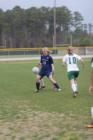 Swansboro's Tylor Ring (23), who scored the game's only goal, looks down as the ball as White Oak's Joy Freeman defends and the Vikings' Chasity Barbour looks on during the Pirates' 1-0 overtime win over White Oak on Friday.