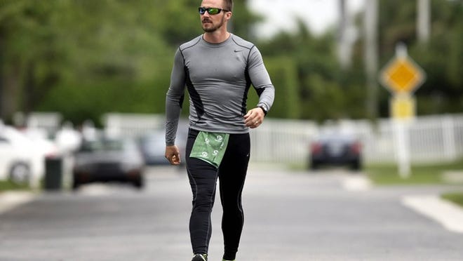 Brian Thomas, a teacher at Okeeheelee Middle School, training for his upcoming walk from West Palm Beach to Washington, D.C. to raise money and awareness for cancer research in Lake Worth. Thomas, who is suffering from melanoma, will make the 1,100 mile journey along with Jean Morris, CEO of Hugs and Kisses, a non profit that assists cancer patients with financial assistance. (Bill Ingram / Palm Beach Post)