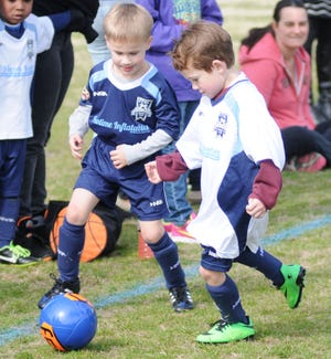 Two boys go for the ball in an Under-5 match in the Cape Fear Youth Soccer Association.