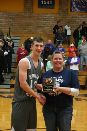 Andrea Barbknecht, repesenting the Kiwanis Club of Canton, presents the MVP plaque to Nate Hopper. the South All-Star helped his team to a 113-104 win.