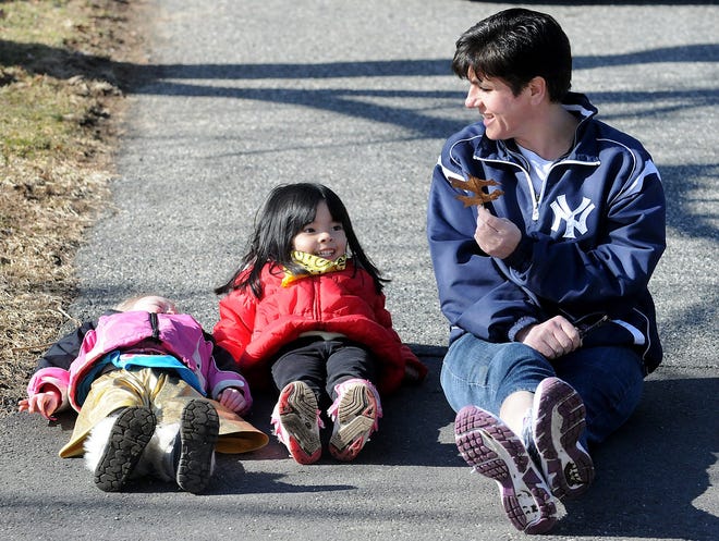 Francine "Sissy" Seeto, who runs a licensed daycare from her home in Framingham, waits for the school bus with Faith Lavoy, 3, left, and Lily Chung, 4.

Daily News Staff Photo/Art Illman