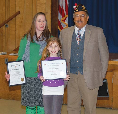 Submitted photo - Art teacher Jennifer Tramayne-Heetema poses with the poster contest first-place winner Brianna Mehan and Past Commander Legion Post 423 Dr. Clifford Williams.