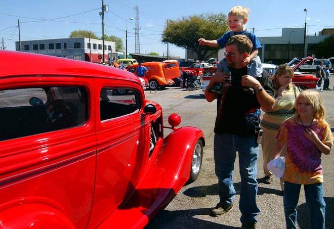 Two-year-old Dylan Quilliams exclaims as he looks at a 1934 Chevy two-door sedan with his father, Mike Quilliams, his mother, Karen Quilliams, and his sister, Kristen Quilliams, during the T-Town Show-Off and Charity Auction Saturday morning in downtown Tuscaloosa. The car is owned by Stephen Hartlein. The event was sponsored by Southern Wheels Car Club and benefitted Tuscaloosa Children's Center. (Carmen Sisson/Tuscaloosa News)