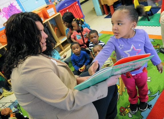 Jada Austin points to a picture in the book 'Horton Hatches the Egg' as read by Liz Johnson during a Read Across America Day event - rescheduled due to weather - at Harvest Child Care Center in Petersburg.