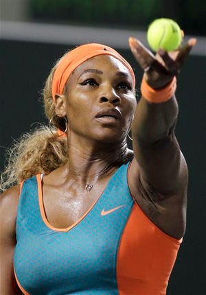 Serena Williams, of the United States, tosses the ball on a serve to Angelique Kerber, of Germany, during the Sony Open tennis tournament, Tuesday, March 25, 2014, in Key Biscayne, Fla. Williams won 6-2, 6-2.(AP Photo/Luis M. Alvarez)