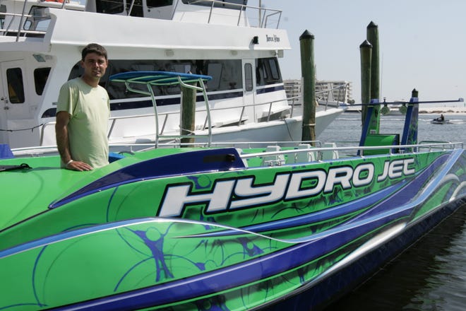 Jordan Bonner stands in the Hydro Jet, the speed boat his father designed, and he completed.