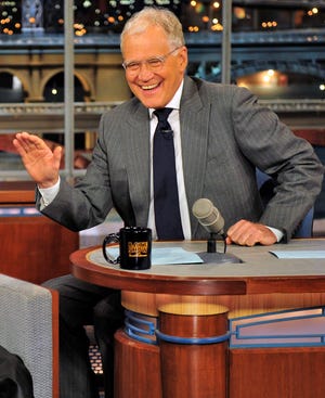 Host David Letterman appears at a taping of his shows"Late Show with David Letterman" in New York. During a taping of his show Thursday, Letterman said he has informed his CBS bosses that he will step down in 2015, when his current contract expires. He told his audience he expects his departure will be "at least a year or so" from now.