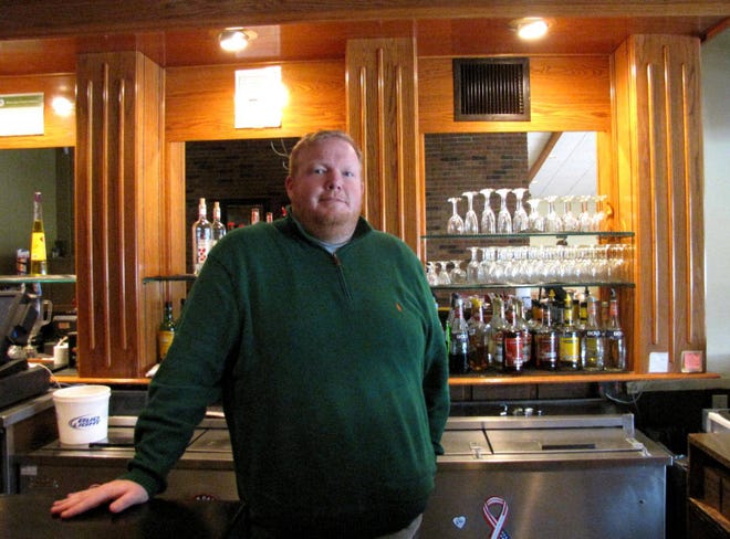 Brad Lowery behind the bar at the soon-to-open Greenside Grill at The Elks Club in Lincoln. Photo by Jessica Lema/The Courier