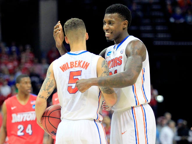 Florida guard Scottie Wilbekin (5) and forward Casey Prather (24) celebrate as the Gators seal their 62-52 win over Dayton late the second half of the Elite Eight on March 29 in Memphis, Tenn.