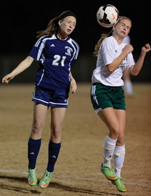 Western Alamance's Cheyenne Floyd, left, and Eastern Alamance's Eliza Krans go up for a head ball during Wednesday night's Mid-State 3-A Conference girls' soccer game.