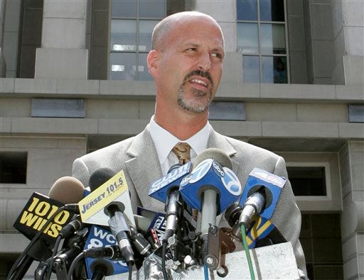 In this Wednesday, Aug. 29, 2007, file photo, Michael Drewniak, spokesman for the U.S. Attorney's office, speaks to reporters outside the U.S. District courthouse in Newark, N.J. Drewniak, a longtime aide to Republican New Jersey Gov. Chris Christie, has given testimony to a federal grand jury in an investigation of traffic jams created near the George Washington Bridge in a political payback scandal. Attorney Anthony Iacullo tells ABC News his client Drewniak is not a target of the investigation but was in federal court to answer questions Friday, April 4, 2014. (AP Photo/Mike Derer, File)