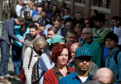 In this Thursday March 13, 2014, file photo, job seekers line up to attend a marijuana industry job far in Downtown Denver. The government issues the March jobs report on Friday, April 4, 2014. (AP Photo/Brennan Linsley, File)