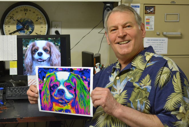 Larry holds a photo of Annie after it comes out of the printer. This shows the contrast between the original and manipulated photo.
