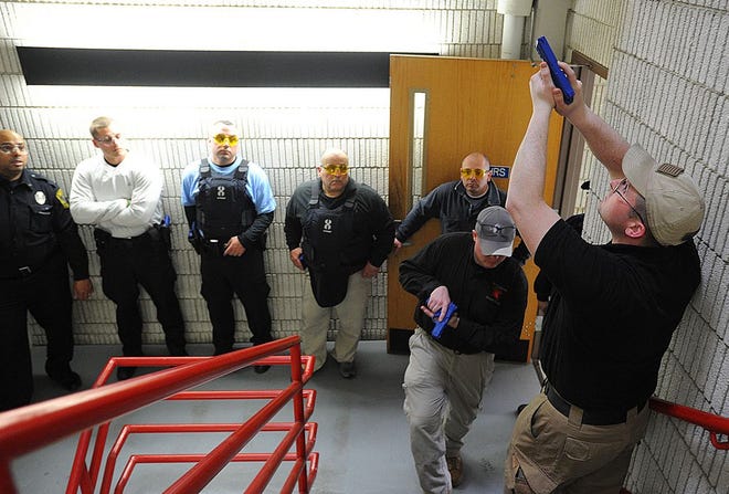 Tactical Operations firearms instructors James Wise and Rob Curran show BCC Police procedures for checking a stairway.