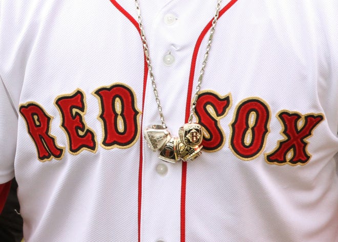 David Ortiz wears his championship rings on a chain before the start of the Opening Day game at Fenway Park.
