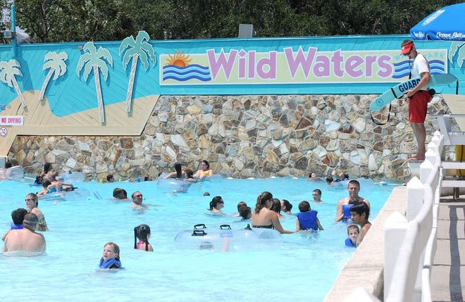 In this June 3, 2012 file photo, a lifeguard watches swimmers in the wave pool at Wild Waters Water Park in Silver Springs. The state's plan for Silver Springs State Park includes phasing out the water park.